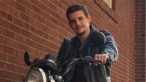 John Elias Tzatzanis on a motorcycle. 